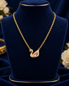 Gold-Tone Pink Swan Necklace on navy velvet display