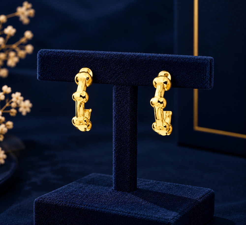 Gold-Tone Mini Geometric Hoop Earrings on navy velvet display