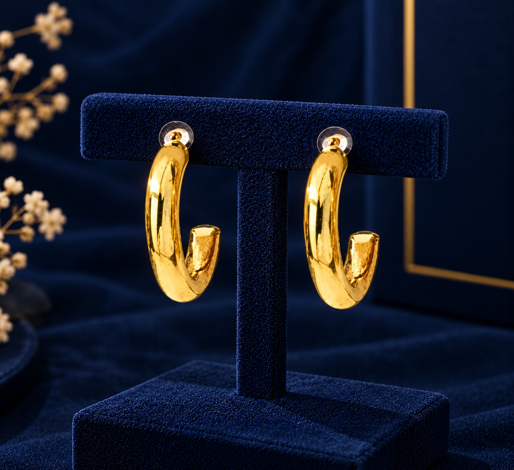 Gold-Tone Open C Hoop Earrings on navy velvet display
