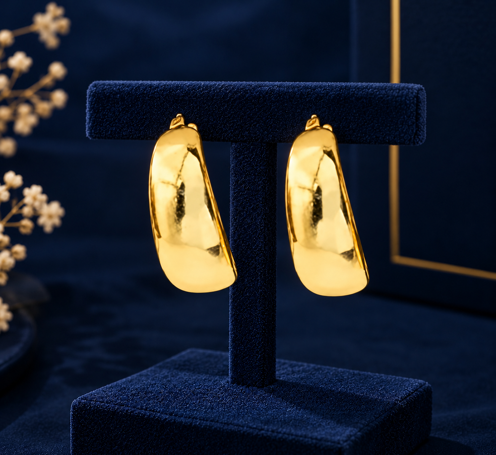 Gold-Tone Wide Polished Hoop Earrings on navy velvet display
