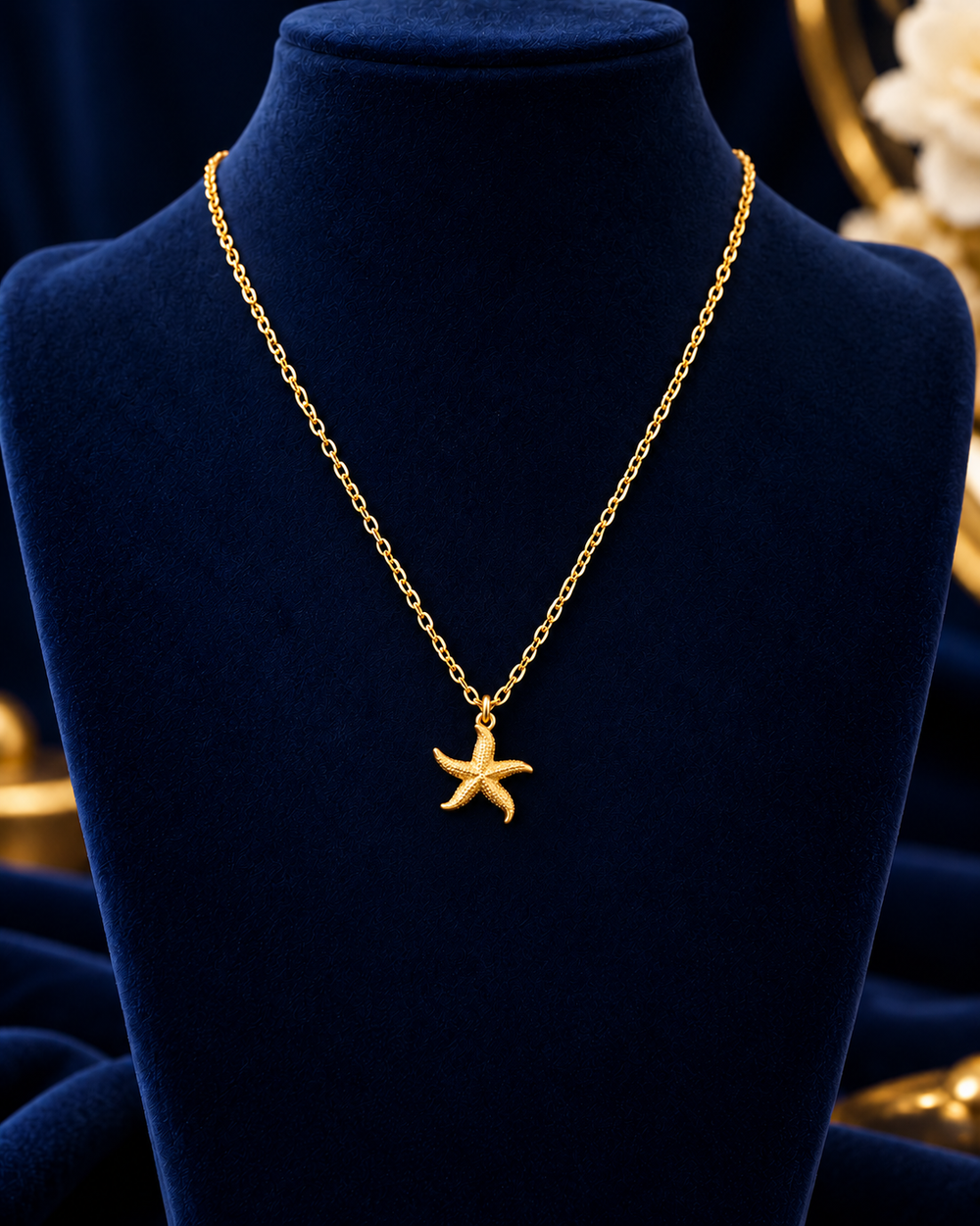 Gold-Tone Starfish Necklace on navy velvet display