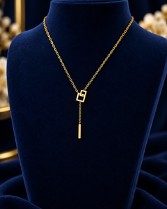 Gold-Tone Geometric Drop Necklace on navy velvet display