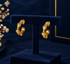 Gold-Tone Mini Geometric Huggie Earrings on navy velvet display