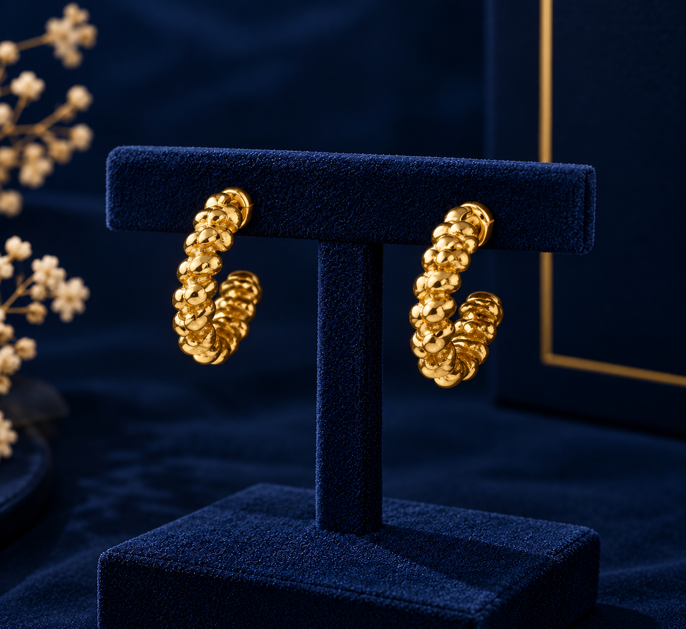 Gold-Tone Textured Mini Huggie Earrings on navy velvet display
