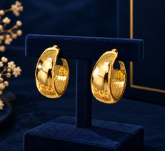 Gold-Tone Wide Dome Hoop Earrings on navy velvet display