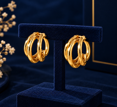 Gold-Tone Double Loop Hoop Earrings on navy velvet display