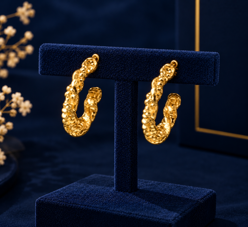 Gold-Tone Beaded Texture Hoop Earrings on navy velvet display