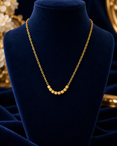 Gold-Tone Cube Bead Necklace on navy velvet display