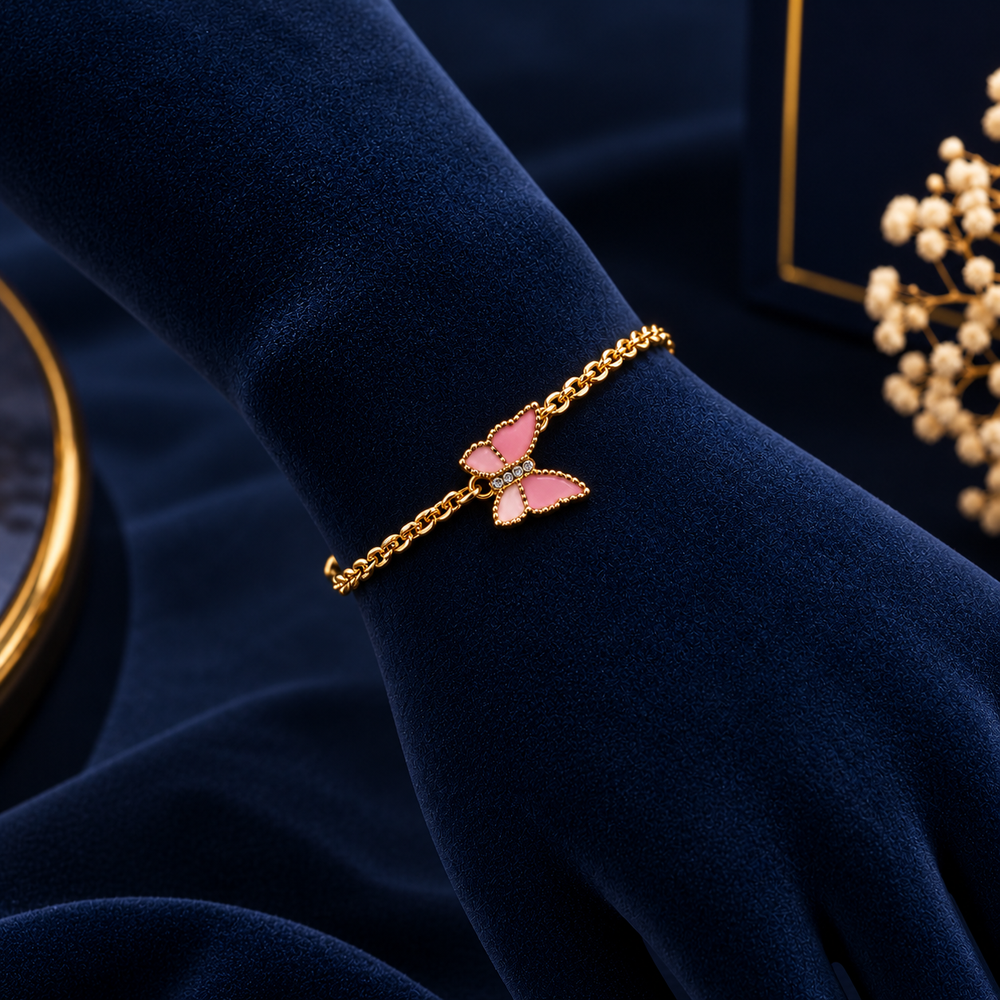 Gold-Tone Pink Butterfly Bracelet on navy velvet display