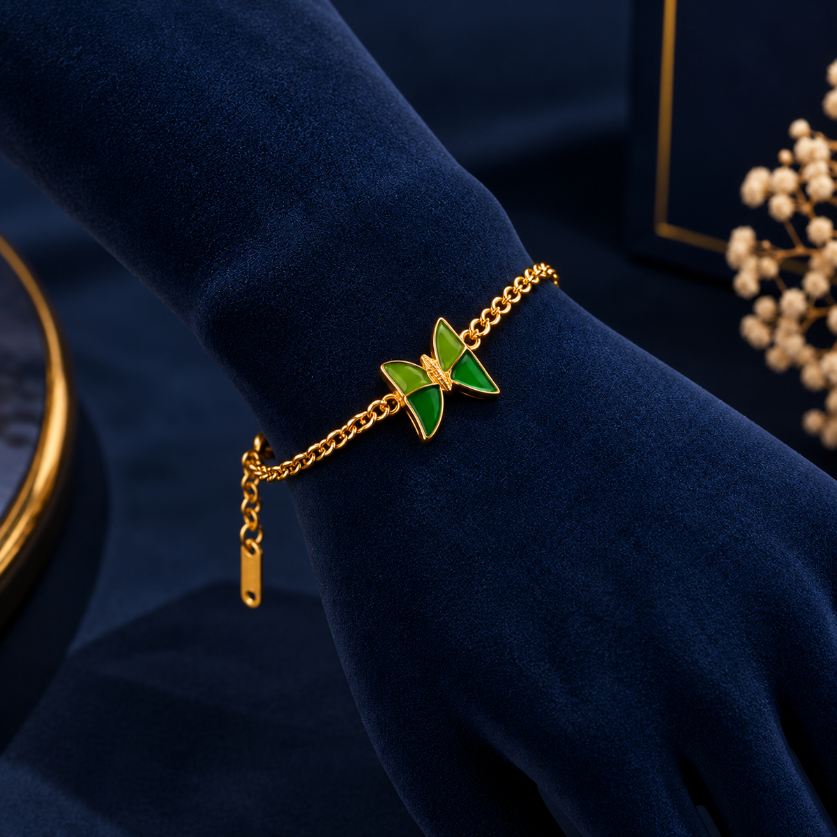 Gold-Tone Green Butterfly Bracelet on navy velvet display