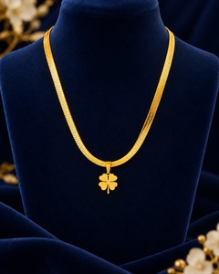 Gold-Tone Four-Leaf Clover Necklace on navy velvet display