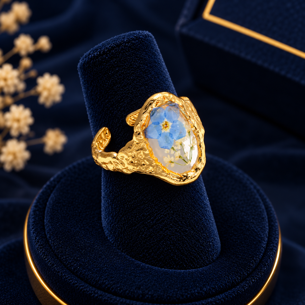 Gold-Tone Blue Flower Drop Ring on navy velvet display