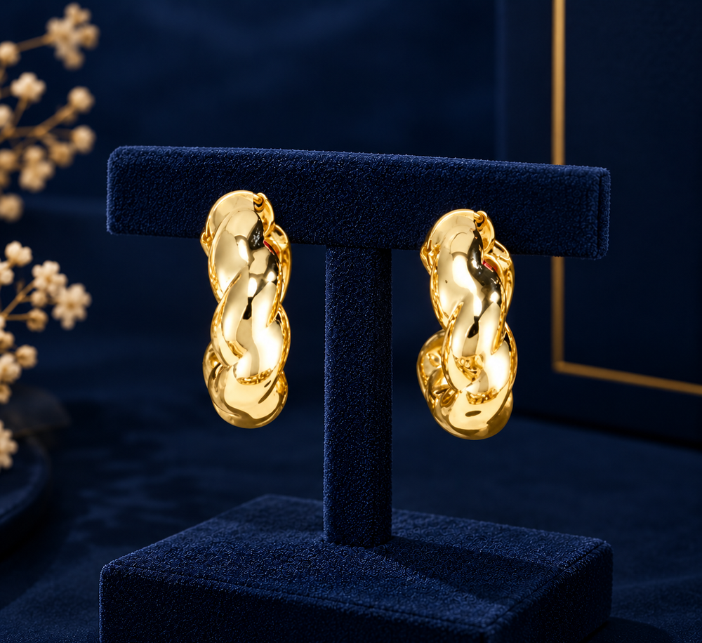 Gold-Tone Organic Twist Hoop Earrings on navy velvet display