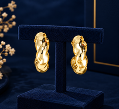 Gold-Tone Organic Twist Hoop Earrings on navy velvet display