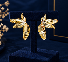 Gold-Tone Sculpted Leaf Statement Earrings on navy velvet display