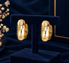 Gold-Tone Tapered Curve Hoop Earrings on navy velvet display