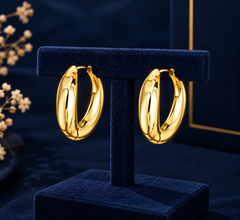 Gold-Tone Classic Oval Hoop Earrings on navy velvet display