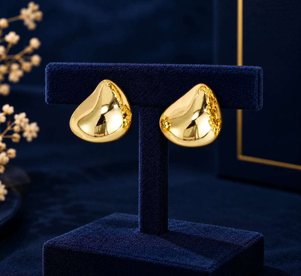 Gold-Tone Sculpted Dome Stud Earrings on navy velvet display