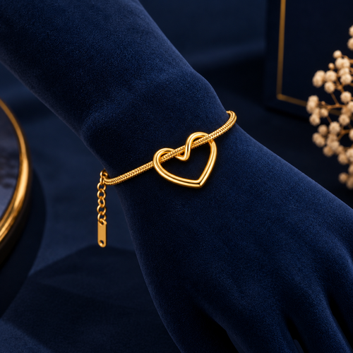 Amora Gold-Tone Heart Bracelet on navy velvet