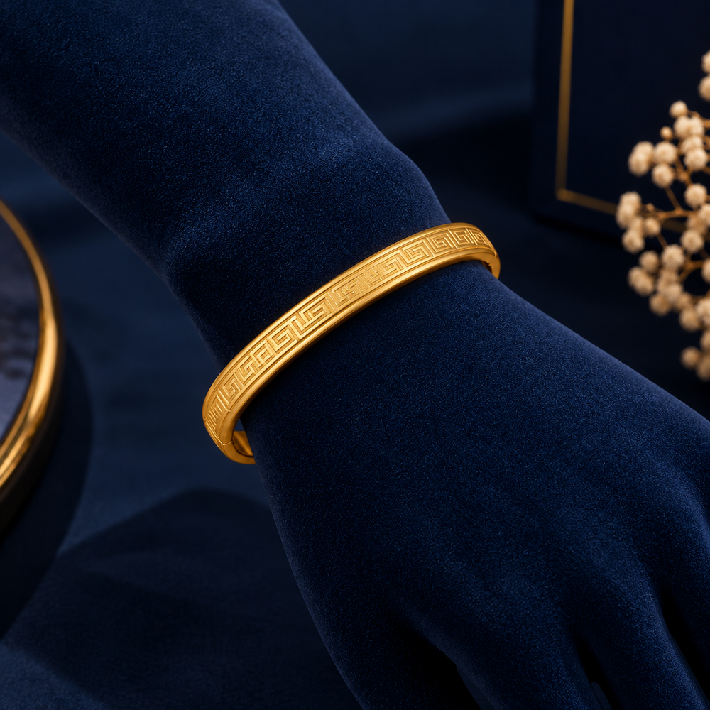 Gold-Tone Greek Key Bracelet on navy velvet