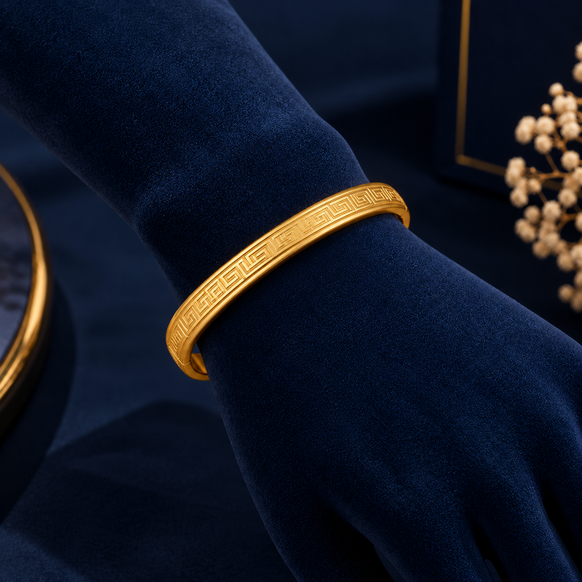 Gold-Tone Greek Key Bracelet on navy velvet