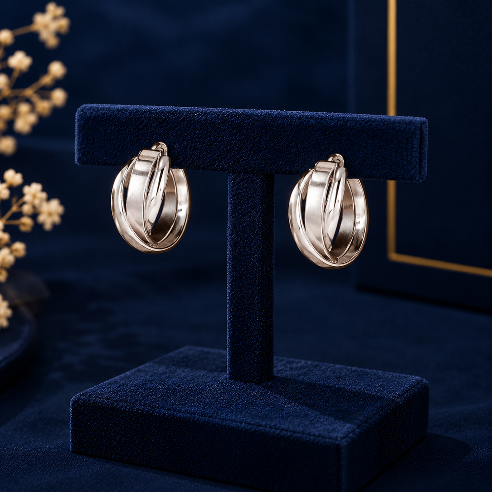 Silver-Tone Intertwined Hoop Earrings on navy velvet