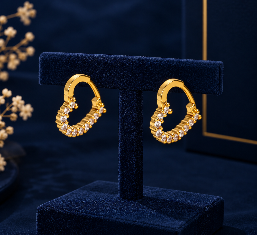 Gold-Tone Crystal Heart Hoop Earrings on navy velvet